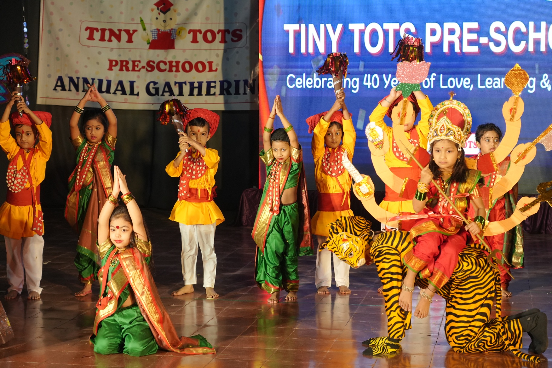 Annual Gathering — children performing in traditional costumes at Tiny Tots Preschool